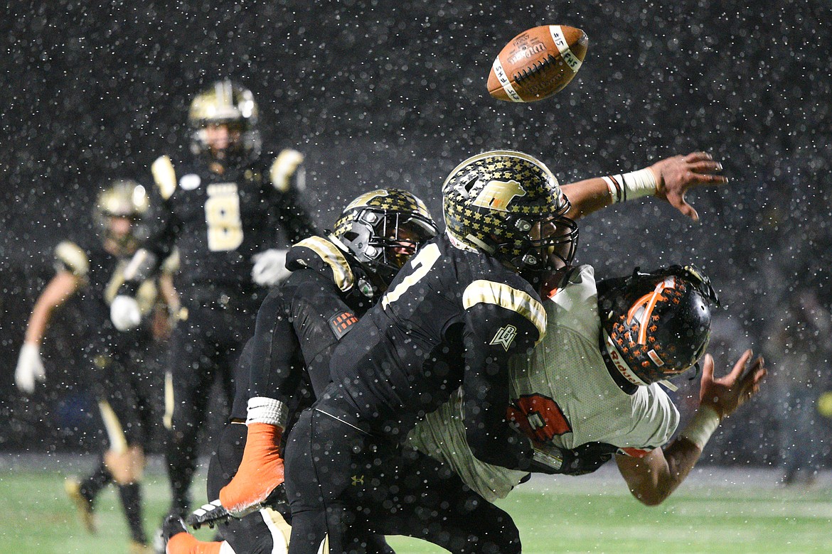 Billings West defenders Trevin Gradney (27, back) and Lucas Gibb (7) break up a pass intended for Flathead wide receiver Anthony Jones in the third quarter of the Class AA state championship at Wendy&#146;s Field at Daylis Stadium in Billings on Friday. (Casey Kreider/Daily Inter Lake)