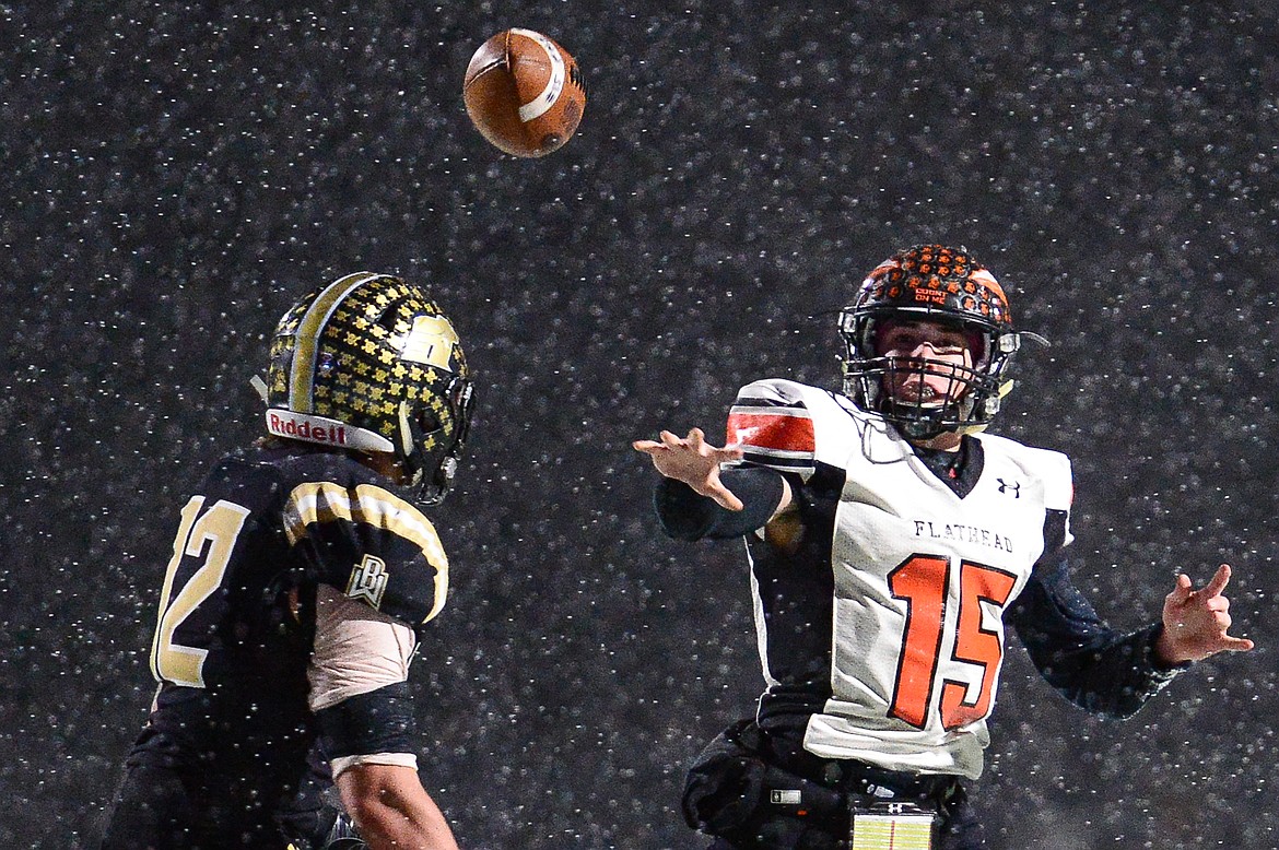 Flathead quarterback Jaden MacNeil (15) tosses a fourth-quarter touchdown pass to wide receiver Anthony Jones (8) against Billings West in the Class AA state championship at Wendy&#146;s Field at Daylis Stadium in Billings on Friday. (Casey Kreider/Daily Inter Lake)