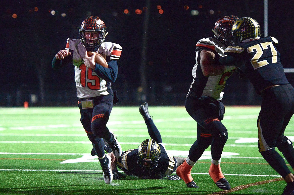 Flathead quarterback Jaden MacNeil (15) scores on a first-half touchdown run against Billings West in the Class AA state championship at Wendy&#146;s Field at Daylis Stadium in Billings on Friday. (Casey Kreider/Daily Inter Lake)