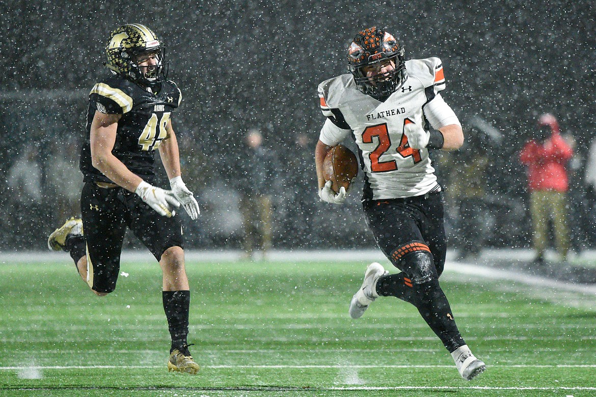 Flathead running back Blake Counts (24) breaks free on a fourth-quarter run that would put the Braves in scoring position down 20-14 in the Class AA state championship against Billings West at Wendy&#146;s Field at Daylis Stadium in Billings on Friday. (Casey Kreider/Daily Inter Lake)