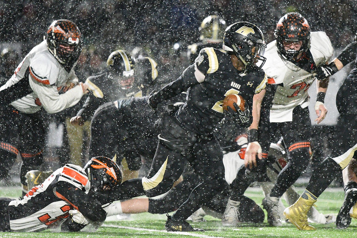 Billings West running back Demarcus Carr (2) looks for running room in the fourth quarter against Flathead in the Class AA state championship at Wendy&#146;s Field at Daylis Stadium in Billings on Friday. (Casey Kreider/Daily Inter Lake)