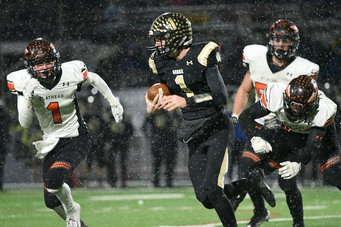 Billings West quarterback Josh Erbacher (1) scrambles for a gain against Flathead in the Class AA state championship at Wendy&#146;s Field at Daylis Stadium in Billings on Friday. (Casey Kreider/Daily Inter Lake)