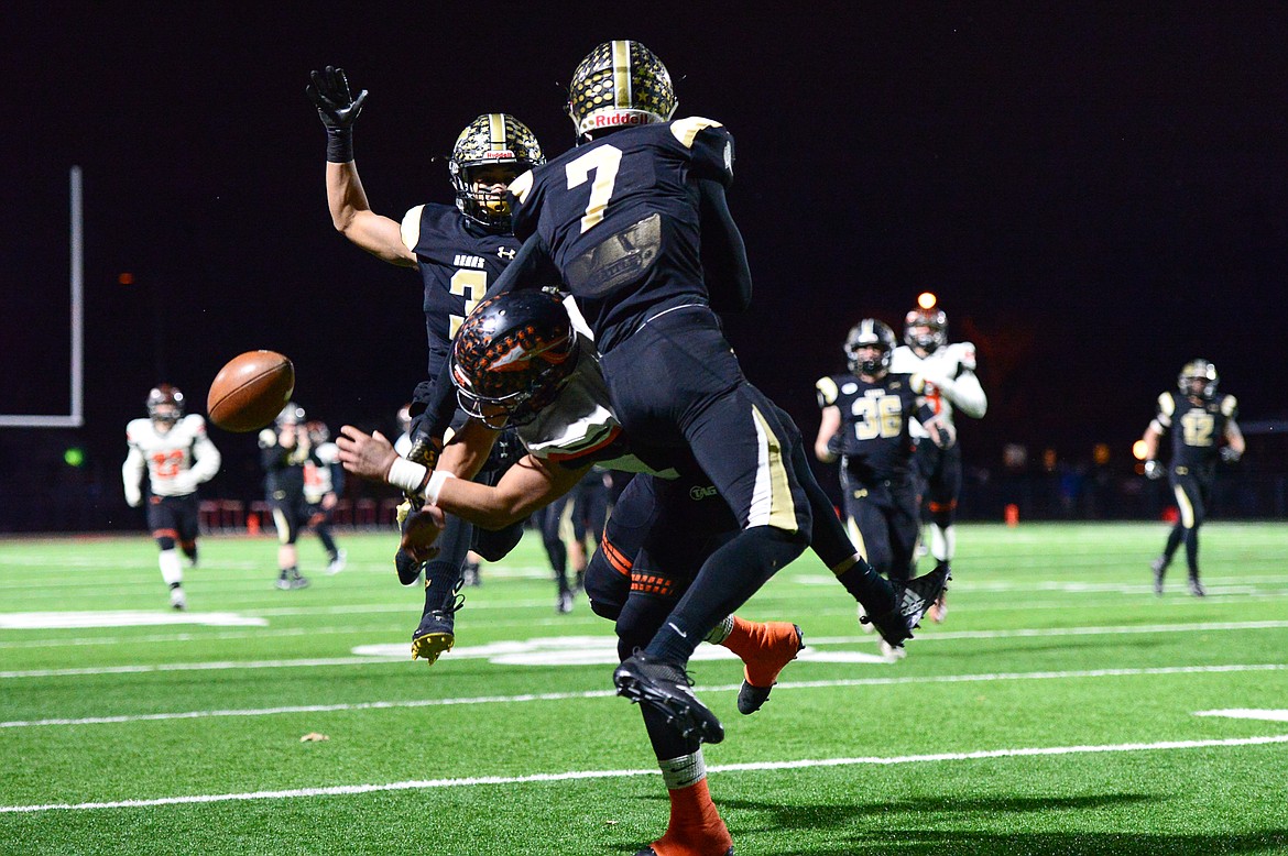 Billings West defensive backs Jesse Owens (3, back) and Lucas Gibb (7) break up a pas intended for Flathead wide receiver Anthony Jones (8) in the Class AA state championship at Wendy&#146;s Field at Daylis Stadium in Billings on Friday. (Casey Kreider/Daily Inter Lake)