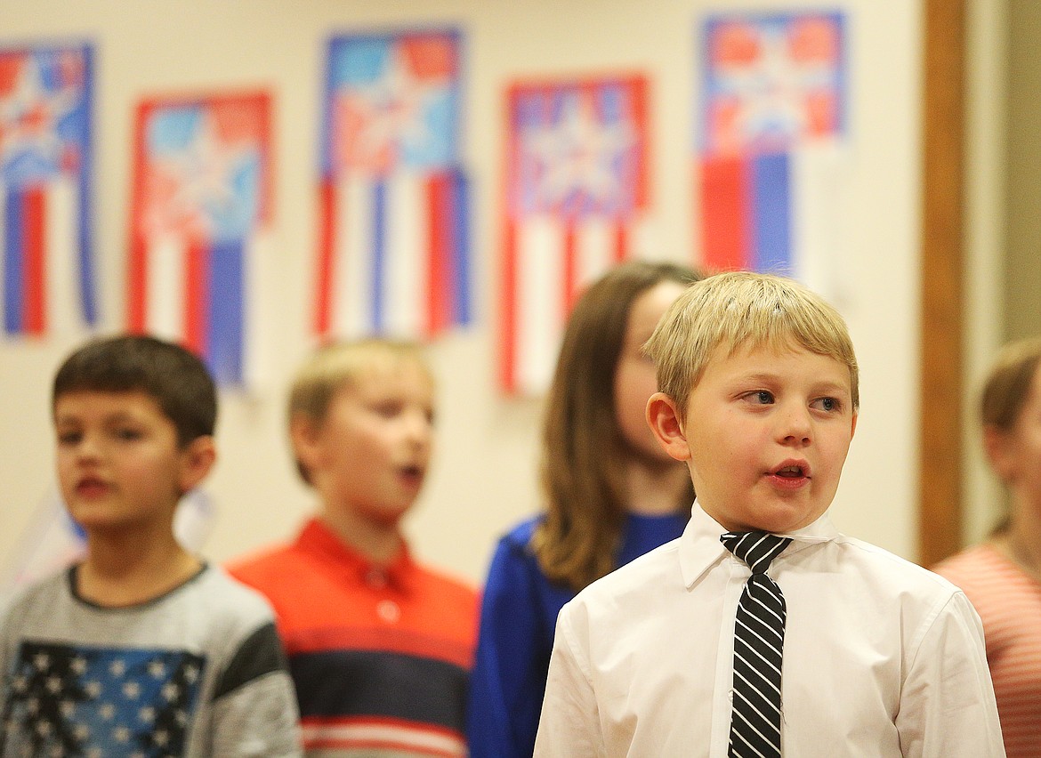 Third-grader Chance Knoles sings &quot;God Bless The USA&quot; with his fellow classmates during Spirit Lake Elementary School's Veterans Day assembly on Monday. (LOREN BENOIT/Press)