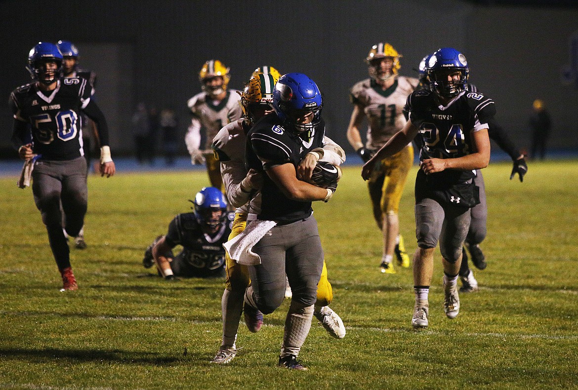 A Borah defender tries to tackle Coeur d&#146;Alene running back Shilo Morgan as he fights forward to the goal line during a state 5A football quarterfinal on Nov. 2 at Viking Field. (LOREN BENOIT/Press)