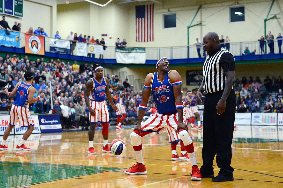 Harlem Globetrotter &quot;Hi-Lite&quot; dances with the referee in a game against the Washington Generals at Glacier High School on Tuesday, Nov. 13. (Casey Kreider/Daily Inter Lake)