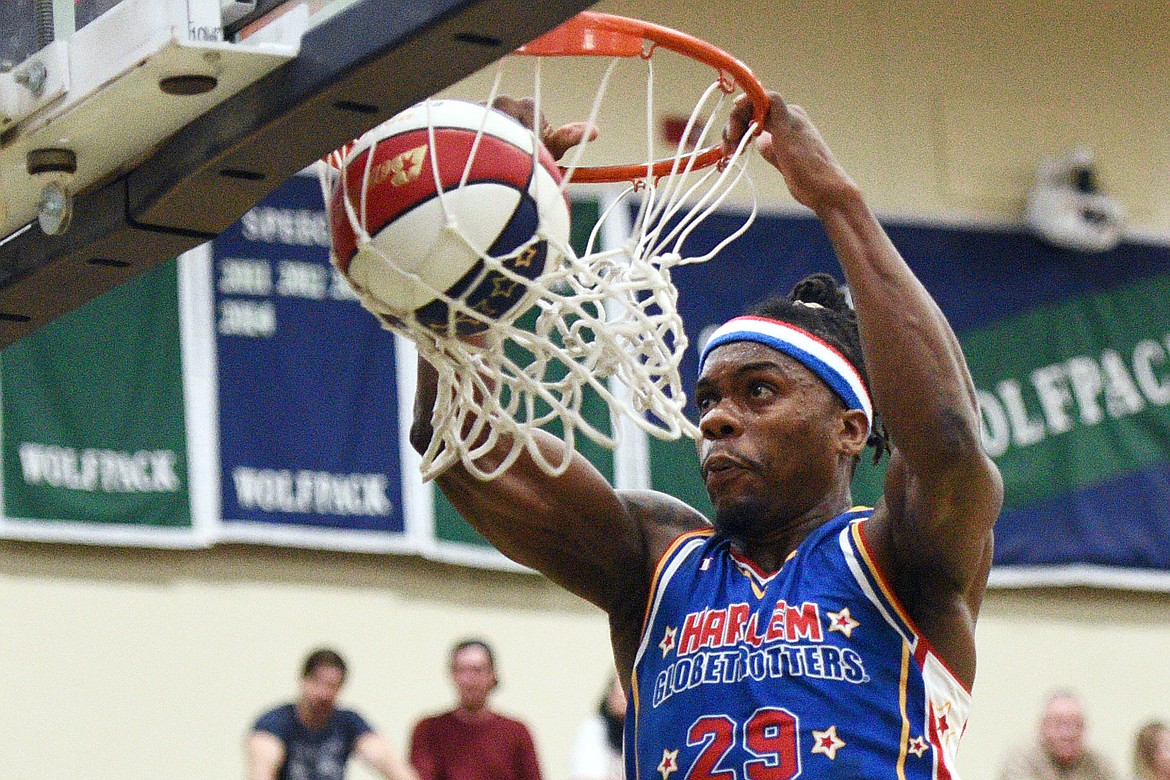 Harlem Globetrotter &quot;Beast&quot; throws down a dunk during a game against the Washington Generals at Glacier High School on Tuesday, Nov. 13. (Casey Kreider/Daily Inter Lake)