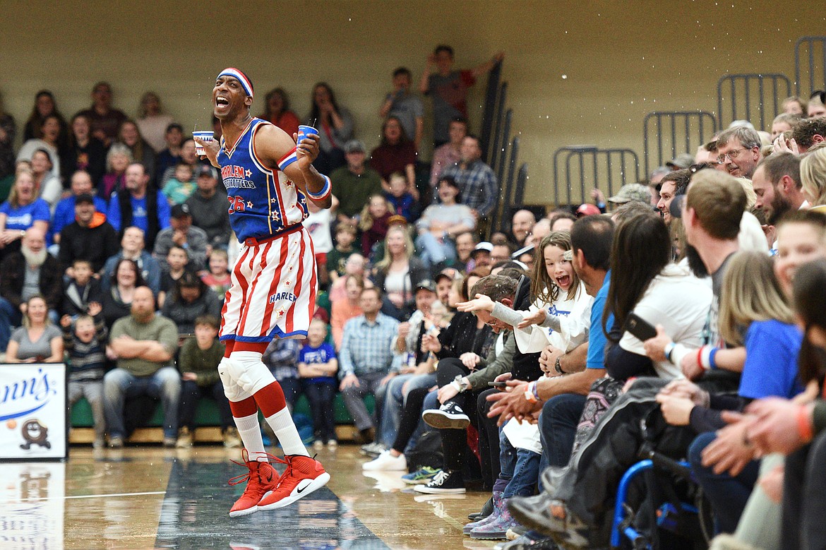 Harlem Globetrotter &quot;Hi-Lite&quot; spills cups of water on a group of fans during a game against the Washington Generals at Glacier High School on Tuesday, Nov. 13. (Casey Kreider/Daily Inter Lake)