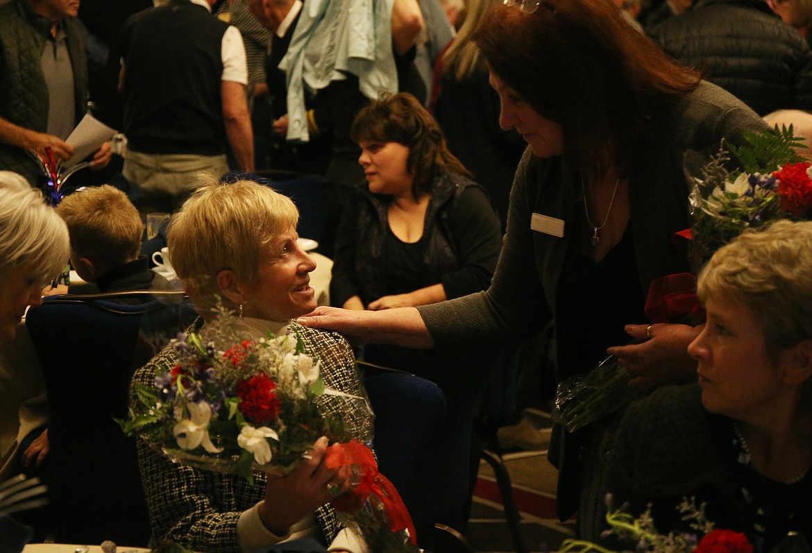 Coeur d&#146;Alene Rotary Club member Marabeth Meyhew recognizes Linda Robinson with a bouquet of flowers at the club&#146;s annual Veterans Lunch on Friday at The Coeur d&#146;Alene Resort. Linda is the wife to Rob, who was recognized for his service in the Army National Guard from 1970-1976. (LOREN BENOIT/Press)