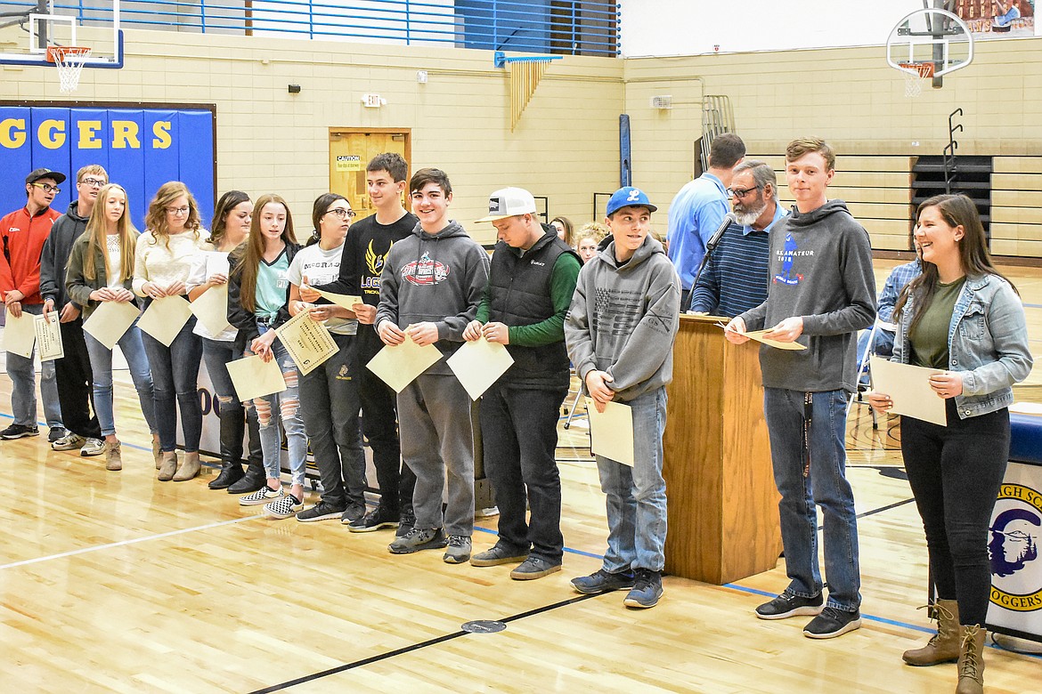 Libby High School golf team Head Coach talks about the accomplishments of his athletes during the Fall Awards Assembly Thursday, including seniors Ryggs Johnston and Sammee Bradeen on the far right. Johnston finished his high school career as a four-time state champion, and Bradeen -- who first picked up a golf club a little overa year ago -- made All State in her second season playing.