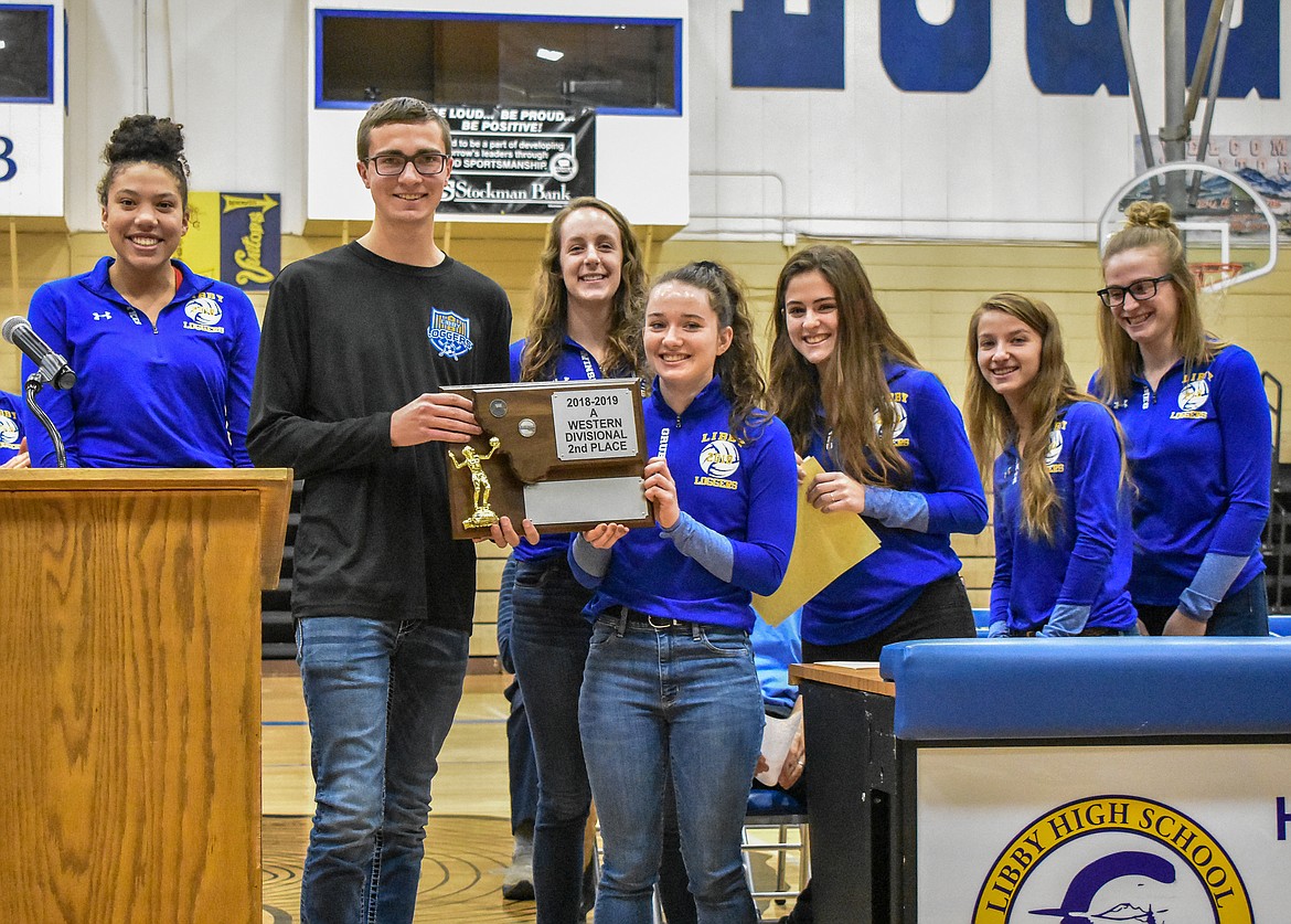 Members of the Libby High School Volleyball team and senior Austin Swartzenberger pose with the 2018-2019 Western A Divisional Second Place trophy during the Fall Awards Assembly Thursday. Pictured are senior Mehki Sykes, Swartzenberger, senior Jayden Winslow, senior Emma Gruber, senior Alli Collins, senior Linsey Walker and senior Jessika Jones.