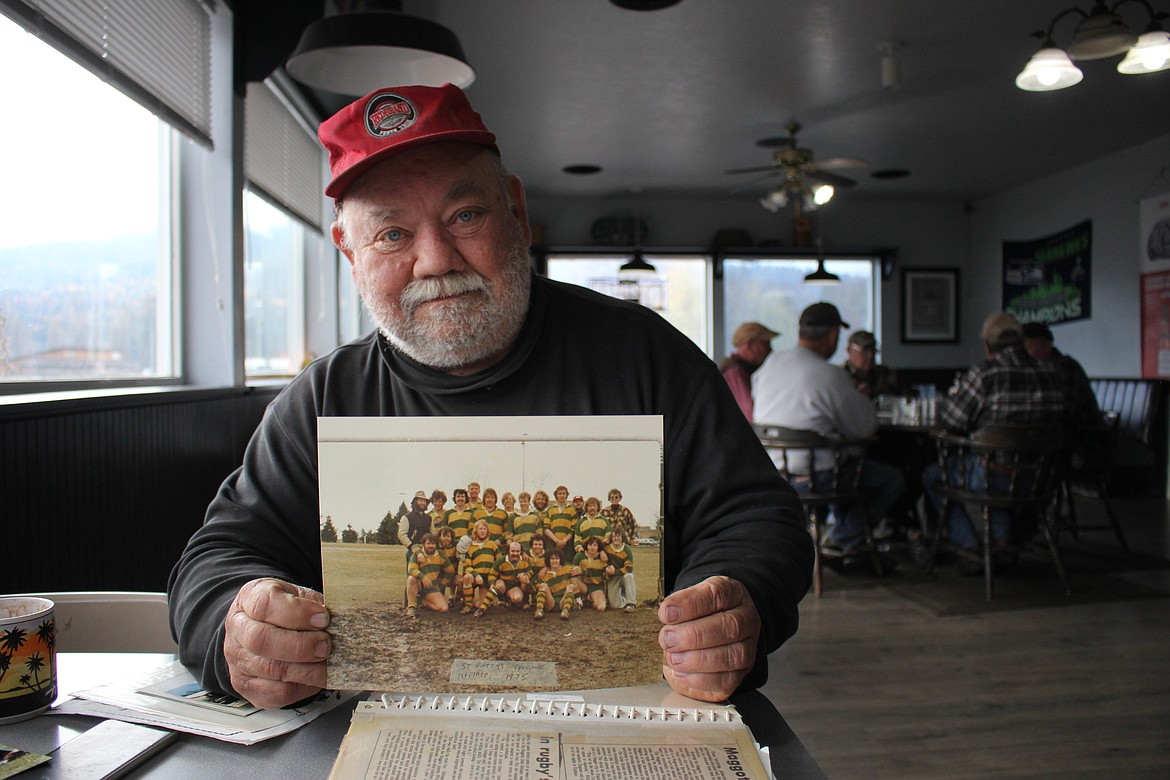 House District 14 Representative Rep. Denley Loge won re-election on Nov. 6. He shows a photo of his early college days playing rugby for the UM Jesters. His suggestion of the team colors being green and gold was accepted, the same colors as St. Regis School. Now, he represents his hometown, as well as the rest of Mineral and Sanders county, in the state legislature. (Kathleen Woodford/Mineral Independent)