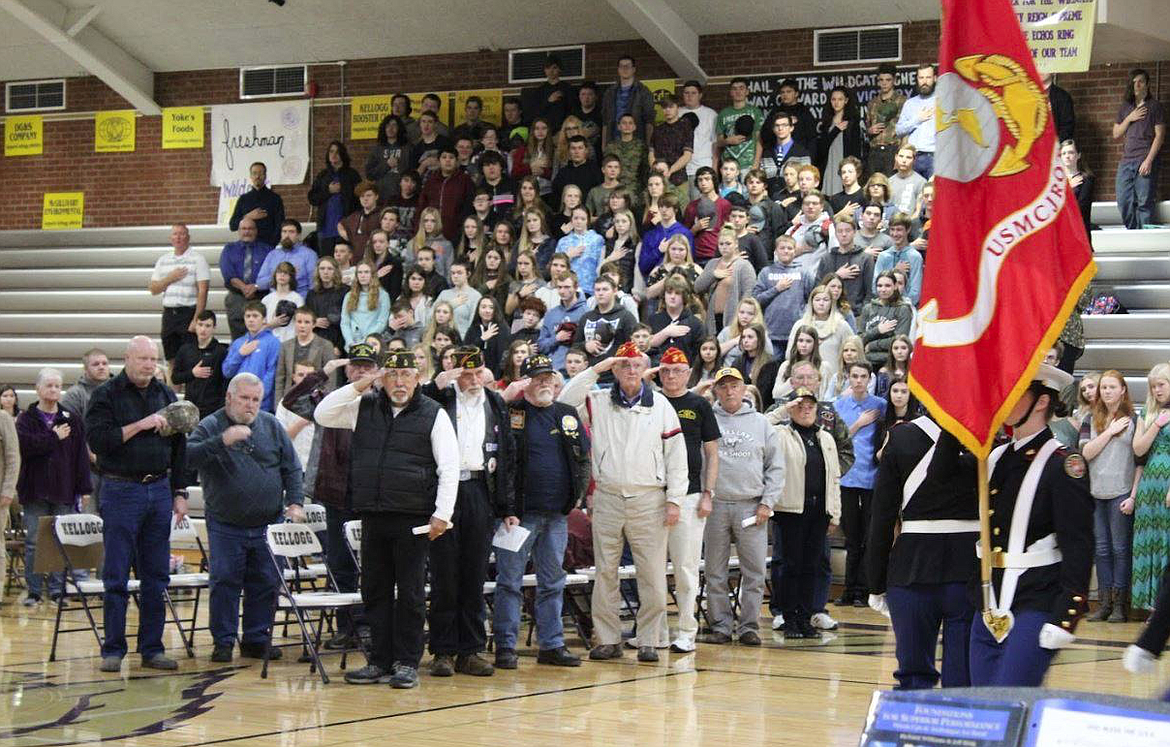 Courtesy photo
Silver Valley veterans and Kellogg High School students stand while the KHS Junior Reserve Officer Training Corps color guard presents the colors last Friday.