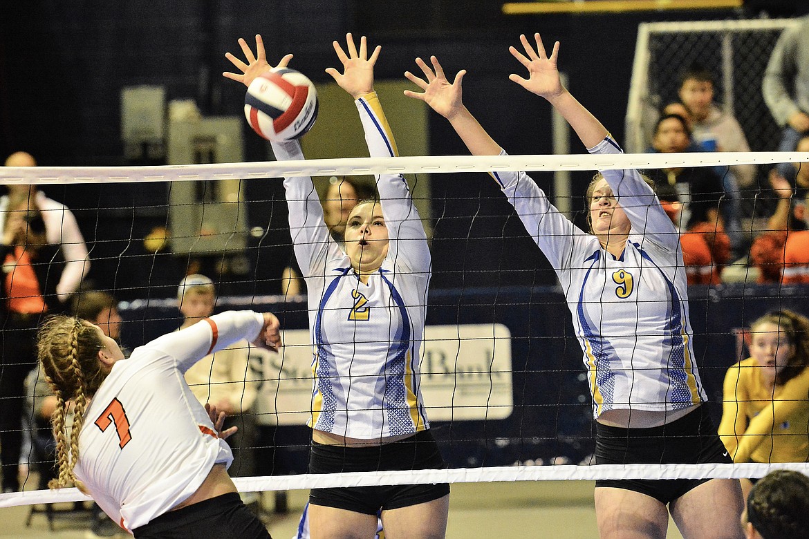 Libby juniors Sheyla Gallagher and Kenzie Proffitt go for a block against Hardin Thursday during the state tournament in Bozeman. (Jeff Doorn)