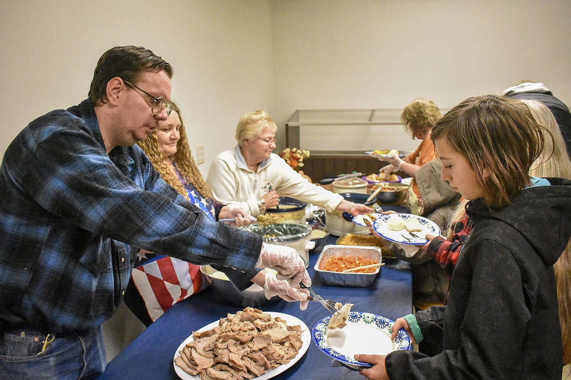 Robert Middleton, Connie Toivonen and Signe Moser &#151; VFW Auxiliary members with VFW John E. Freeman Post 5514 &#151; serve up dinner to veterans and their families during the annual Veterans Day dinner at the Troy post Sunday. (Ben Kibbey/The Western News)