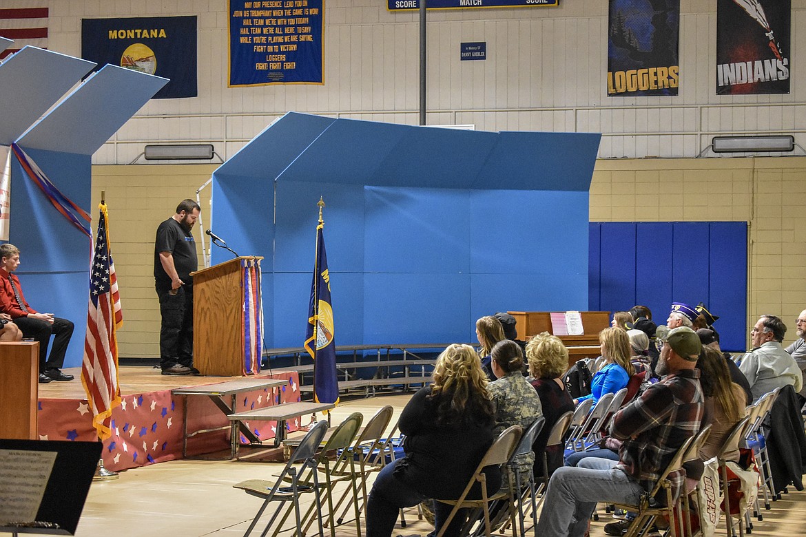 U.S. Marine Corps veteran Ramsey Smith addresses students, community members and fellow veterans during the Veterans Day observance in the Ralph Tate Memorial Gymnasium at Libby High School Monday. Smith gave a frank recollection of growing up with his brother, Raleigh, in Troy, of their enlistment in the Marines around the same time, and the mental and emotional scars he carries from his own service and from the death of his brother in Fallujah, Iraq. He told the audience that being asked if he ever killed someone or to tell stories of his time overseas is painful, but that the gratitude shown when people thank service members for their service makes it worth the sacrifices made. (Ben Kibbey/The Western News)