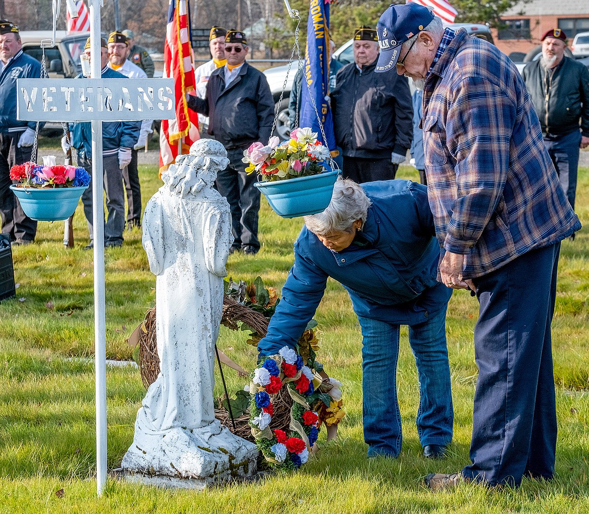 Gold Star mother Maria Wegner, accompanied by husband Don Wegner, leave a wreaths in honor of veterans during a Veterans Day memorial service at Libby Cemetery Sunday, Nov. 11, 2018. (John Blodgett/The Western News)