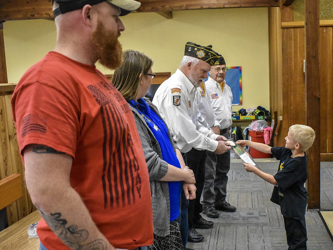 Local veterans &#151; including members of VFW Harper Erdman Post 1548 &#151; visited Libby Elementary School Friday, where the kindergarten class presented them with custom &#147;Thank you&#148; cards made in the likeness of soldiers. Pictured are local veterans Skylar Cochran, Rose Arnold, John Beebe, Paul Mammano and Leo LaBelle. Acton Farmer is presenting to John Beebe. (Ben Kibbey/The Western News)