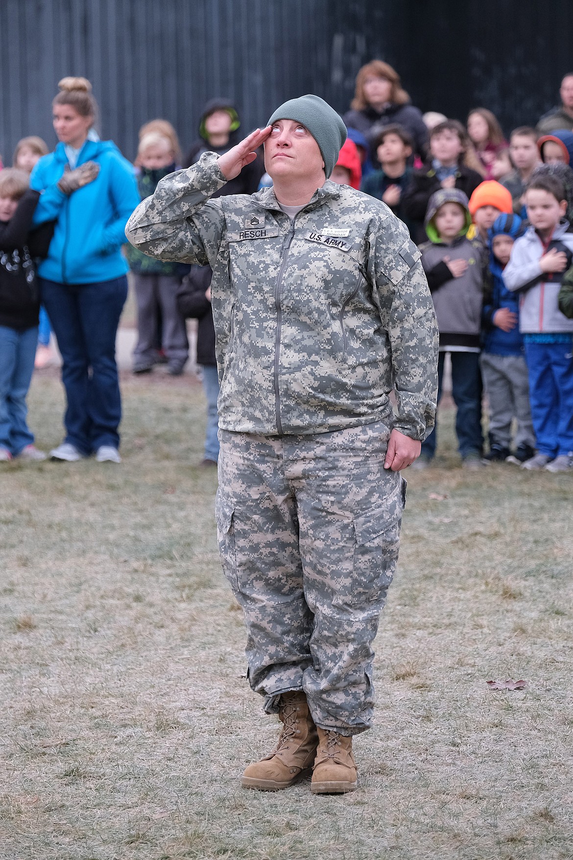 Tina Resch salutes the flag during a Veterans Day ceremony at Libby Elementary School Monday morning. (John Blodgett/The Western News)