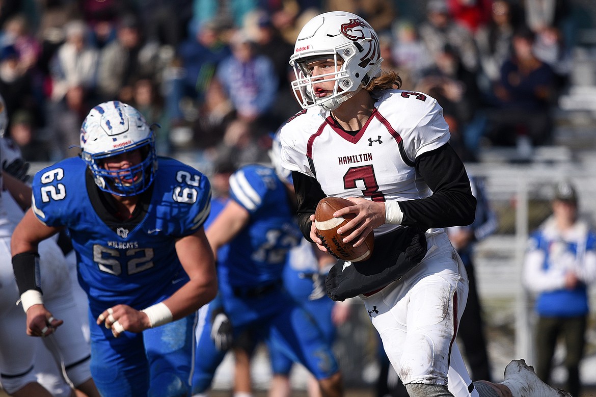 Hamilton quarterback Carson Rostad (3) looks for room to run against Columbia Falls in a Class A semifinal playoff game at Columbia Falls High School on Saturday. (Casey Kreider/Daily Inter Lake)