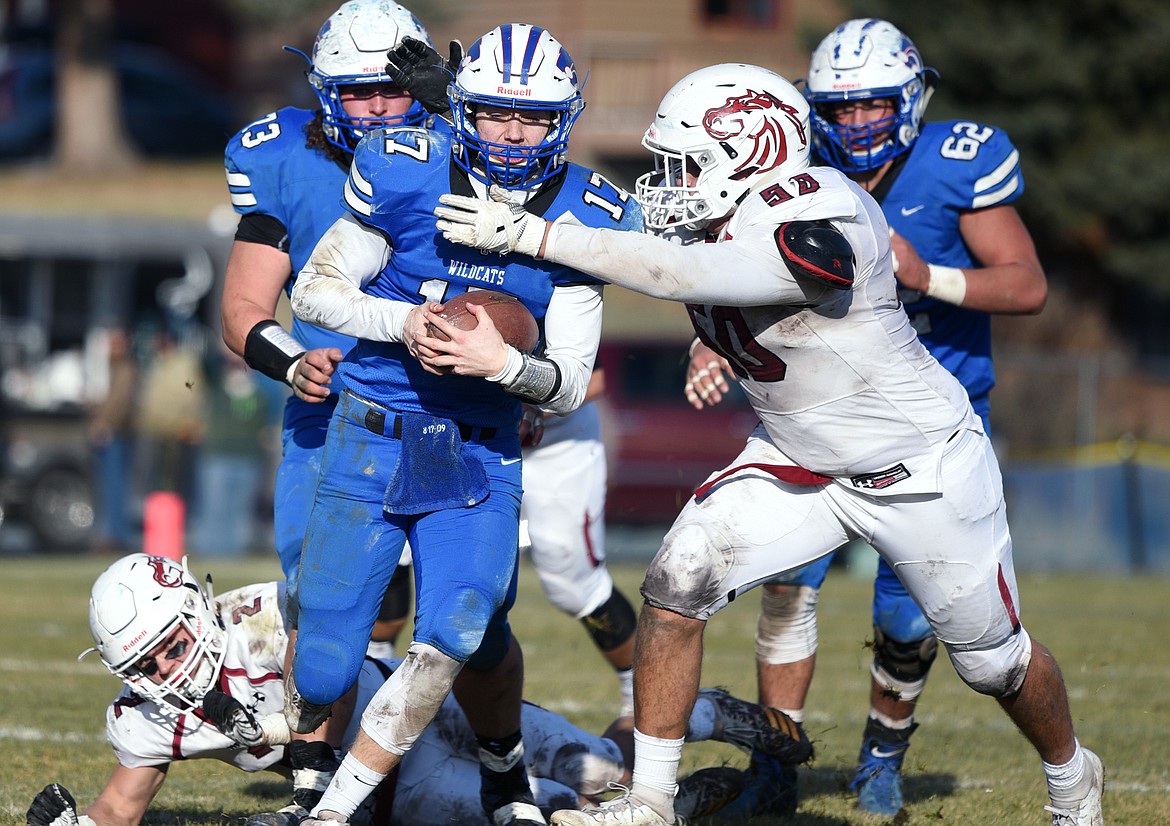 Columbia Falls quarterback Drew Morgan (17) is flushed from the pocket by Hamilton defender Mike Graves (50) in the third quarter in a Class A semifinal playoff game at Columbia Falls High School on Saturday. (Casey Kreider/Daily Inter Lake)