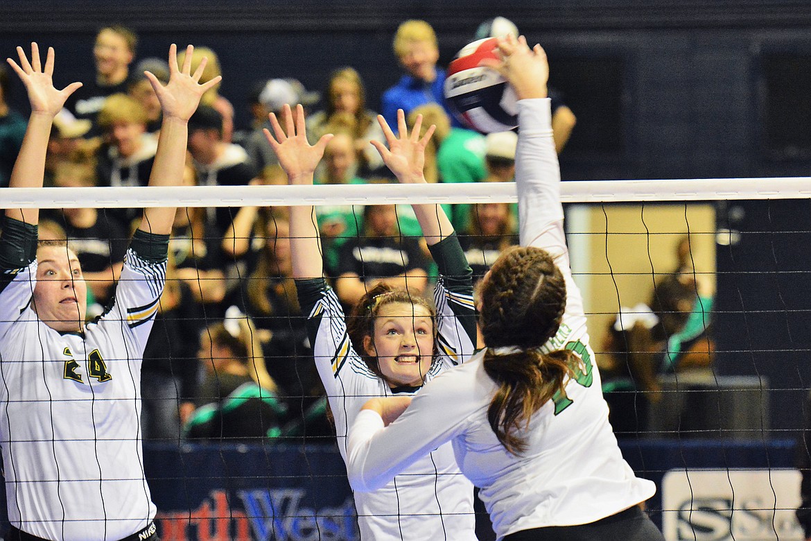 Marlee Bender and Kaiah Moore look to block a Belgrade spike in the Class A State Tournament last week in Bozeman.