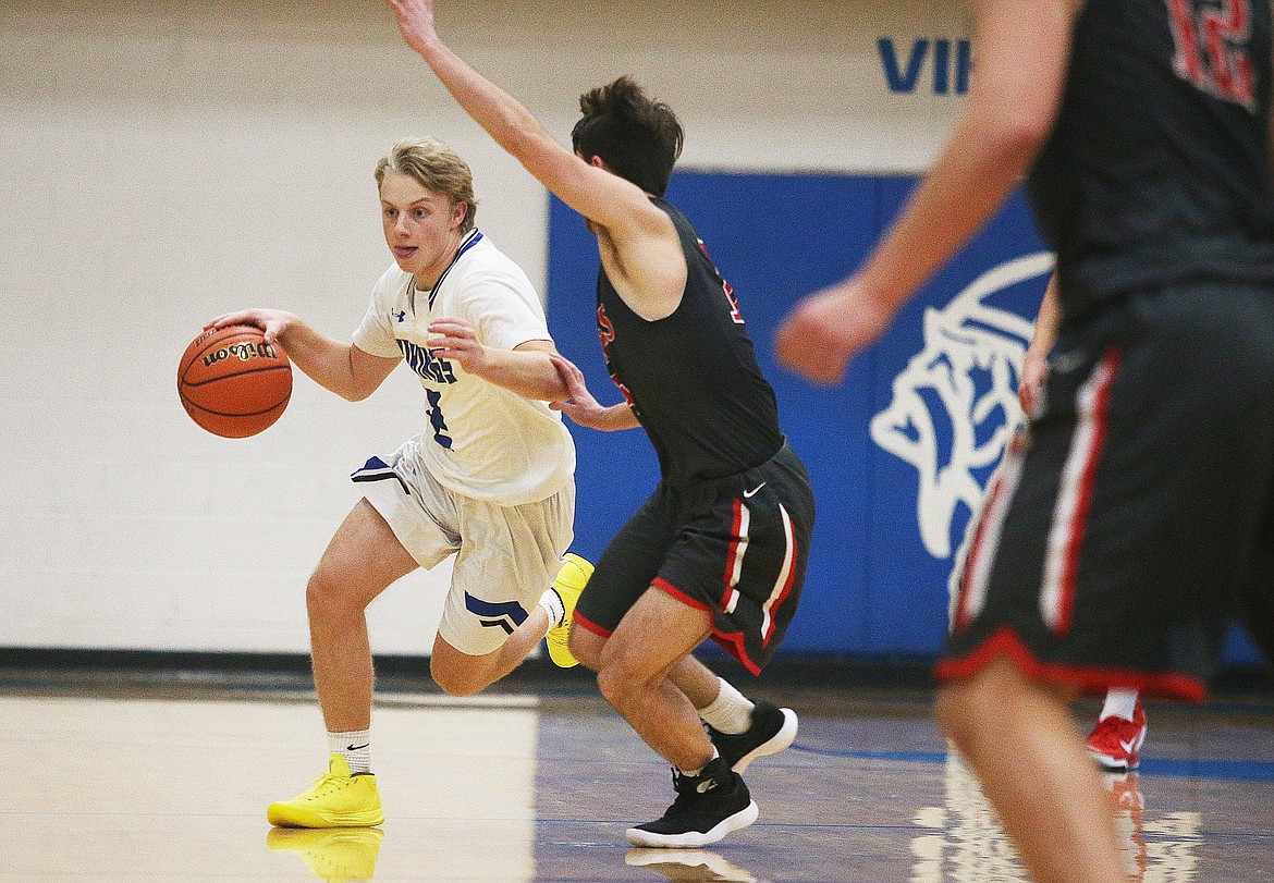 Coeur d&#146;Alene&#146;s Mayson Blakeley-Whittaker dribbles the ball down the court next to Ferris defender Kellen Erickson in Tuesday night&#146;s game at Viking Court. (LOREN BENOIT/Press)