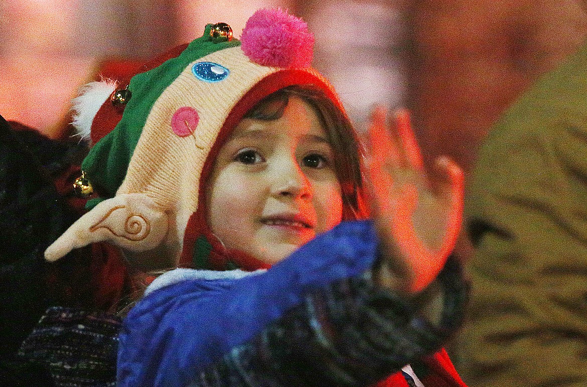 Luna Mae, 6, of Rathdrum, waves to Santa as he makes his way down the Holiday Parade route. (LOREN BENOIT/Press)