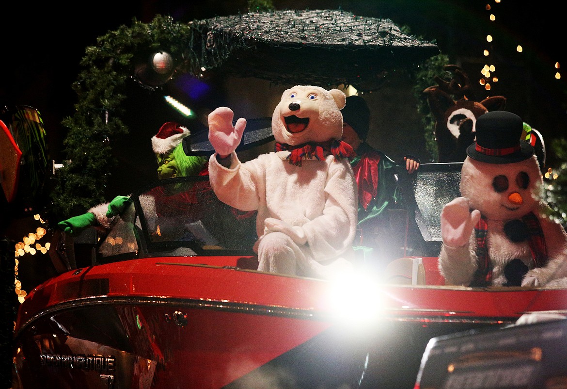 A polar bear waves to the crowd from a float during Friday night's Holiday Parade on Sherman Avenue. (LOREN BENOIT/Press)