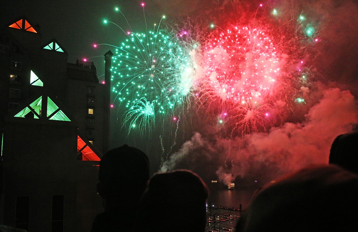 Red and green fireworks light up the sky above Lake Coeur d'Alene during the 32nd annual Coeur d'Alene Resort Holiday Light Show. (LOREN BENOIT/Press)