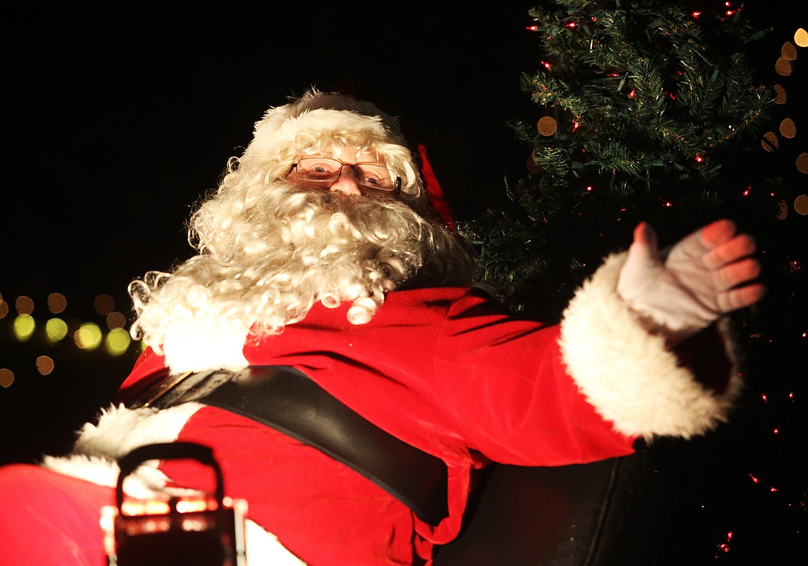 Santa Claus waves from his firetruck &quot;sleigh&quot; to the some 30,000 people lining Sherman Avenue at the holiday Parade preceding the 29th Annual Coeur d'Alene Resort Holiday Light Show on Friday. (LOREN BENOIT/Press)