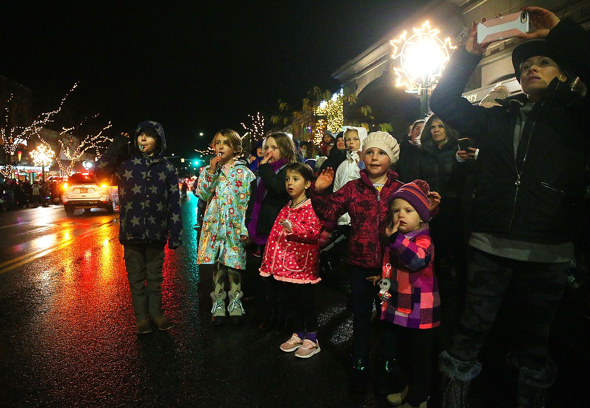 Kids wave as The Blazen Divas make their way down the Holiday Parade route Friday night. (LOREN BENOIT/Press)