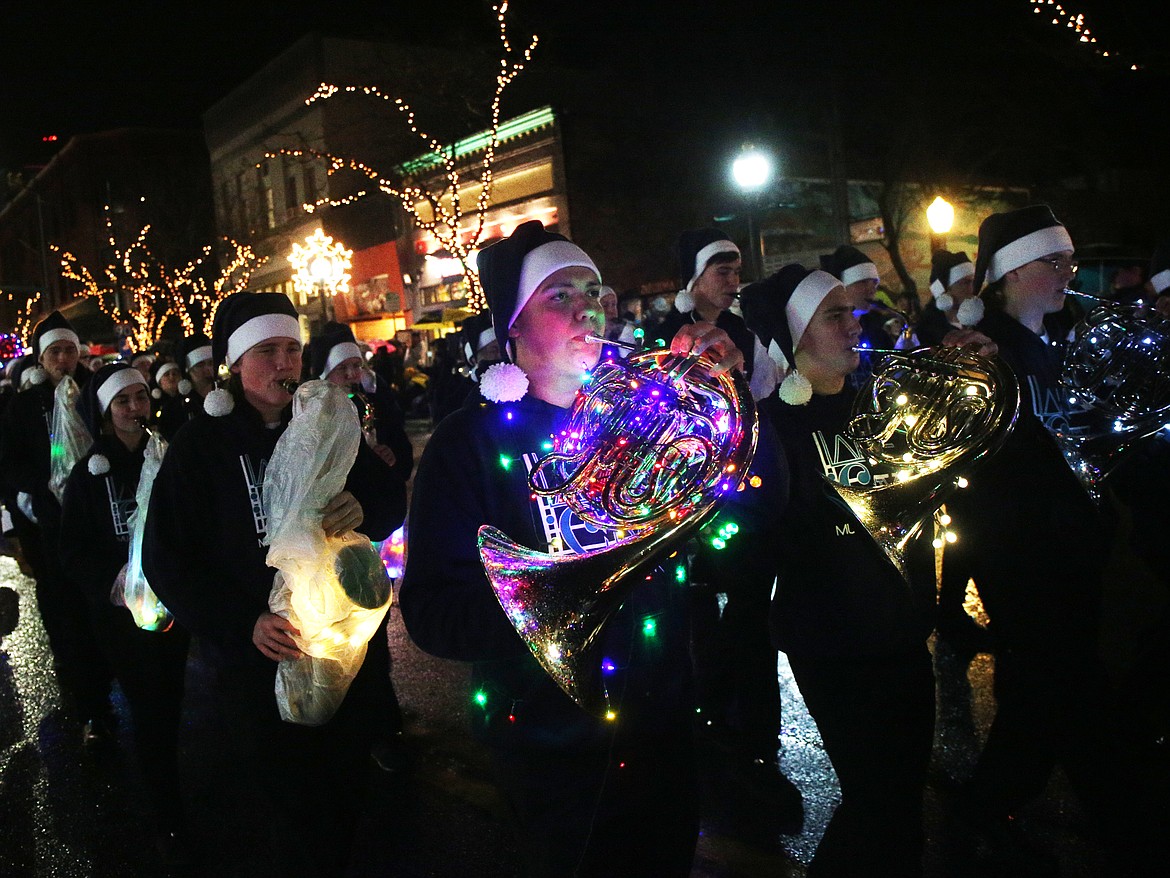 Dylan Cobb with the Lake City High School marching band plays a tune on the French horn while performing in the Holiday Parade on Sherman Avenue.