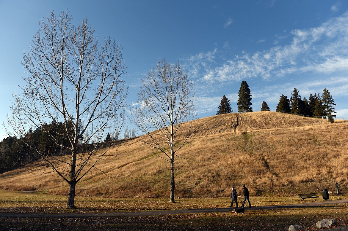 A couple walk their dog around Lawrence Park in Kalispell on Tuesday, Nov. 20. (Casey Kreider/Daily Inter Lake)