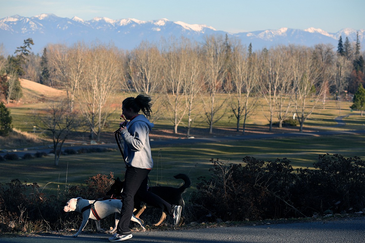 A woman takes her dogs for a run at Lawrence Park in Kalispell on Tuesday, Nov. 20. (Casey Kreider/Daily Inter Lake)