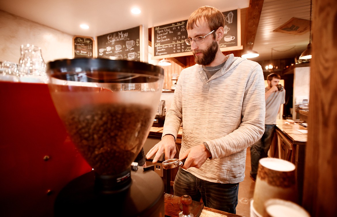 Troy Yost begins making a latte at the Dobson Creek Coffee Co. in Ronan on Nov. 13.