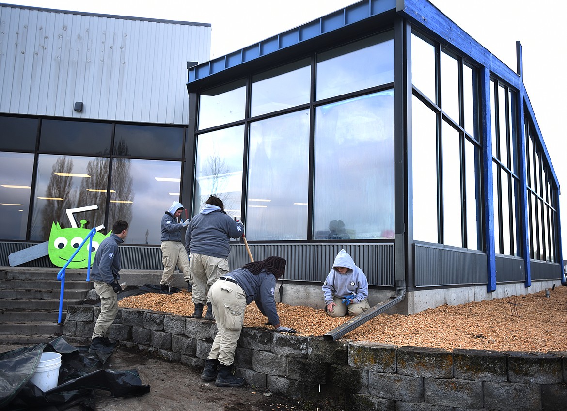 AmeriCorps workers tackle landscaping outside the new home of the Boys and Girls Club of Flathead Reservation and Lake County on Tuesday, Nov. 13, in Ronan. (Brenda Ahearn photos/Daily Inter Lake)