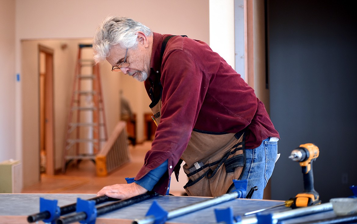 Gene DeCarlo of Charlo using his woodworking skills on the front desk area of the under construction Boys and Girls Club of Flathead Reservation and Lake County on Tuesday, November 13, in Ronan. DeCarlo said that he and other volunteers were happy to be working on the project to give back to the community and to give opportunities to area youth.(Brenda Ahearn/Daily Inter Lake)