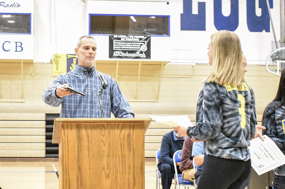 Libby High School girls soccer Head Coach Eric Kapan presents the &#147;Most Improved&#148; team award to senior Lauren Thorstenson during the Fall Awards Assembly Thursday. (Ben Kibbey/The Western News)