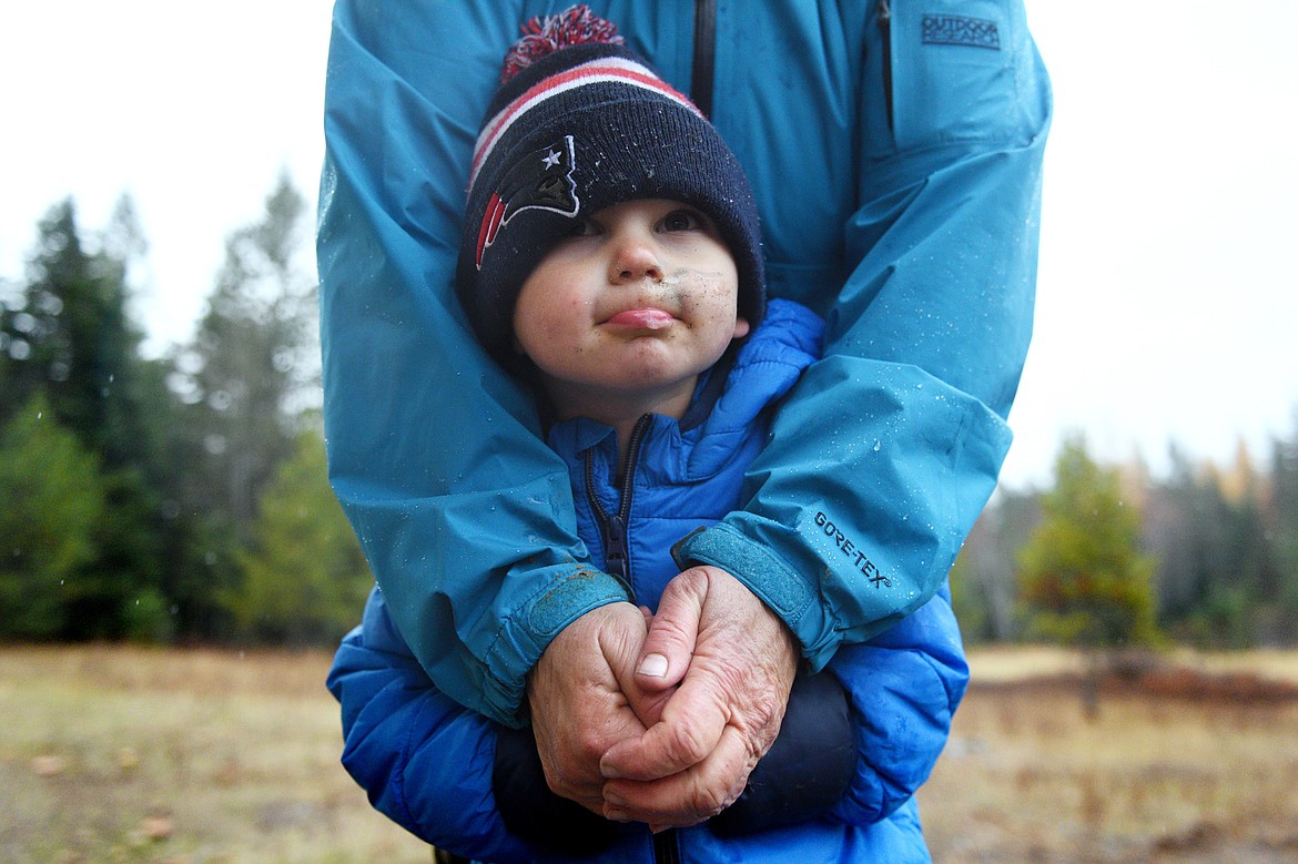 Teacher-assistant Jean Kramer warms Remy Bitterauff&#146;s hands after Bitterauf&#146;s gloves got wet on a hike at Foxtail Forskola at Earthstar Farms in Whitefish on Wednesday, Oct. 31. Foxtail Forskola is a Scandinavian-inspired forest school where nature is the classroom. Children ages 3-6 spend nearly all of the school day outdoors learning social and emotional readiness through free play and nature-based activities on a 35-acre organic farm. (Casey Kreider/Daily Inter Lake)