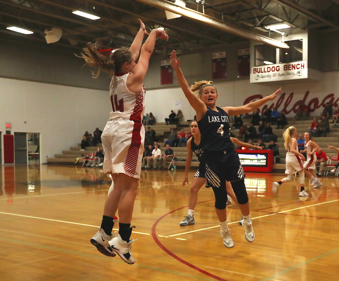 (Photo by KYLE CAJERO) Lake City guard Chloe Teets contests Sandpoint guard Maddie Morgan&#146;s three-point attempt.