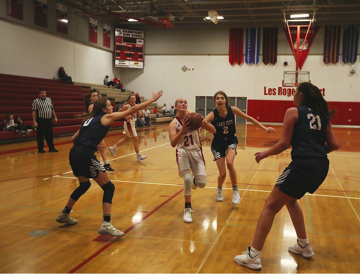 (Photo by KYLE CAJERO)
Sandpoint sophomore Hattie Larson splits several Lake City defenders on Tuesday night.