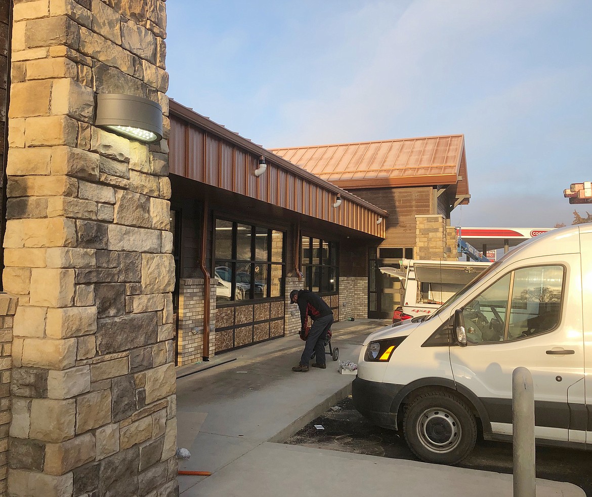 The exterior of the new Town Pump in Plains features attractive, modern styling with lots of brick work. Behind the stone upright is a larger Lucky Lil&#146;s Casino. (Photo courtesy of Town Pump)