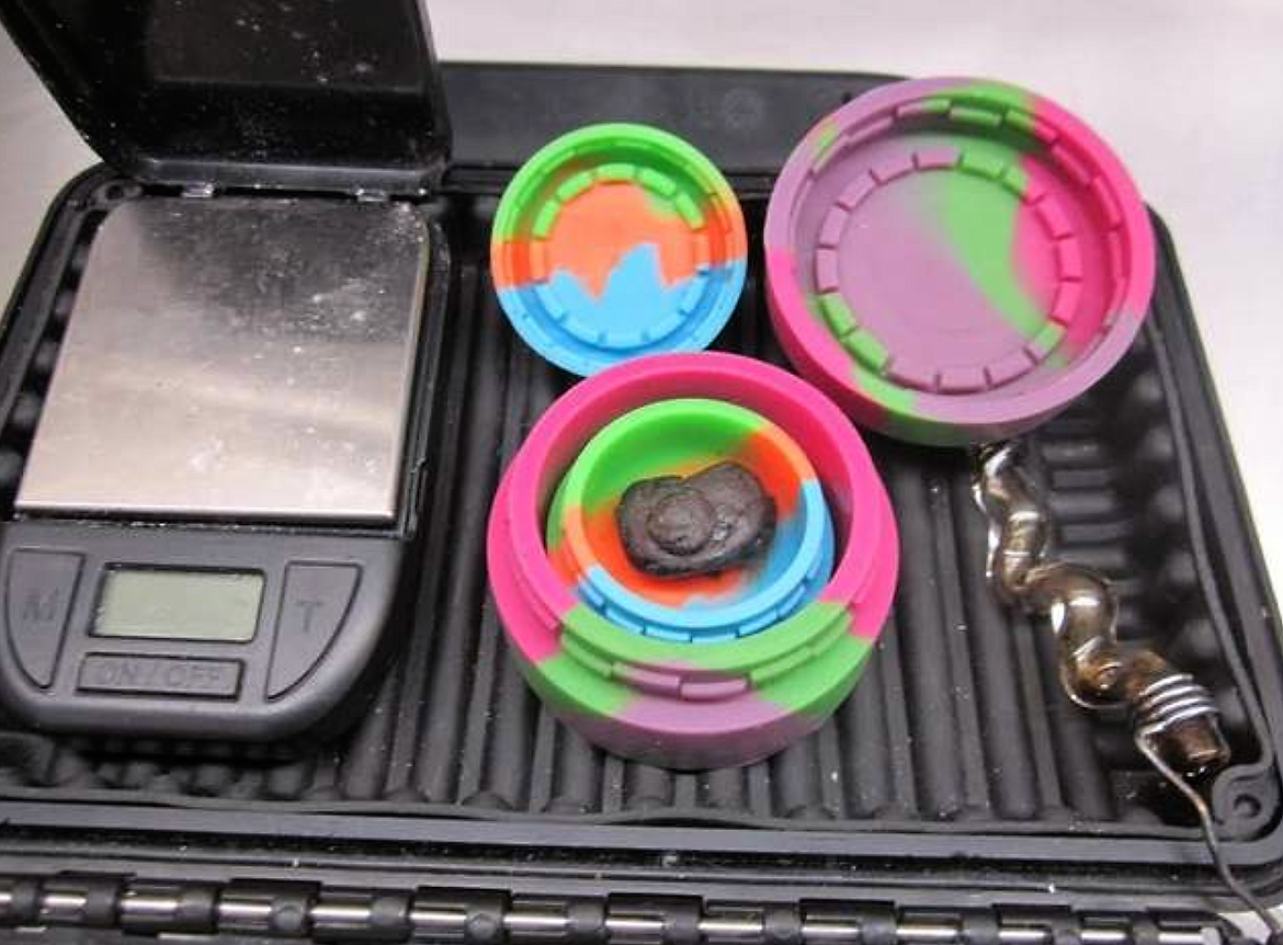 Photo courtesy of Idaho State Police/Black tar heroin, drug paraphernalia and a stolen gun were seized by Idaho State Police during a traffic stop on Interstate 90 in Post Falls on Wednesday night.