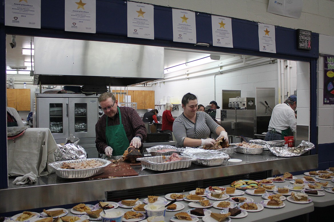 Photo by TANNA YEOUMANS
Volunteers assist with serving the community at the annual Thanksgiving dinner hosted by the Boundary County Ministerial Association. It was served Sunday, Nov. 18, at Bonners Ferry Middle School. As this photo shows, a wide variety of pies were part of the menu.