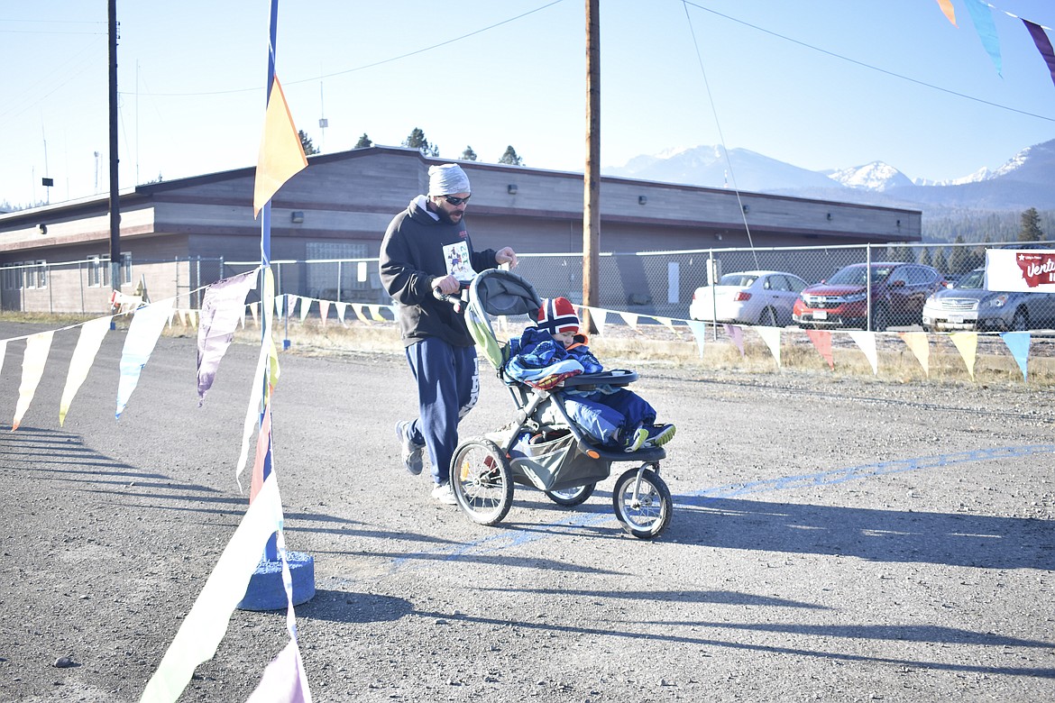 Cody Katzer brings up the rear, close behind his family with the stroller, during the Turkey Dash 5k on  Saturday. (Ben Kibbey/The Western News)