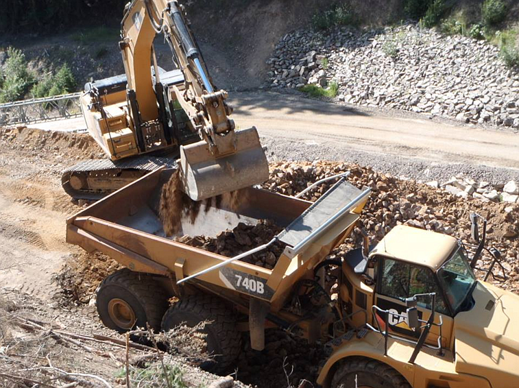 A loader fills one of the many truckloads of waste materials that was taken from the Success Mine, just a few miles north of Wallace near Nine Mile Creek.