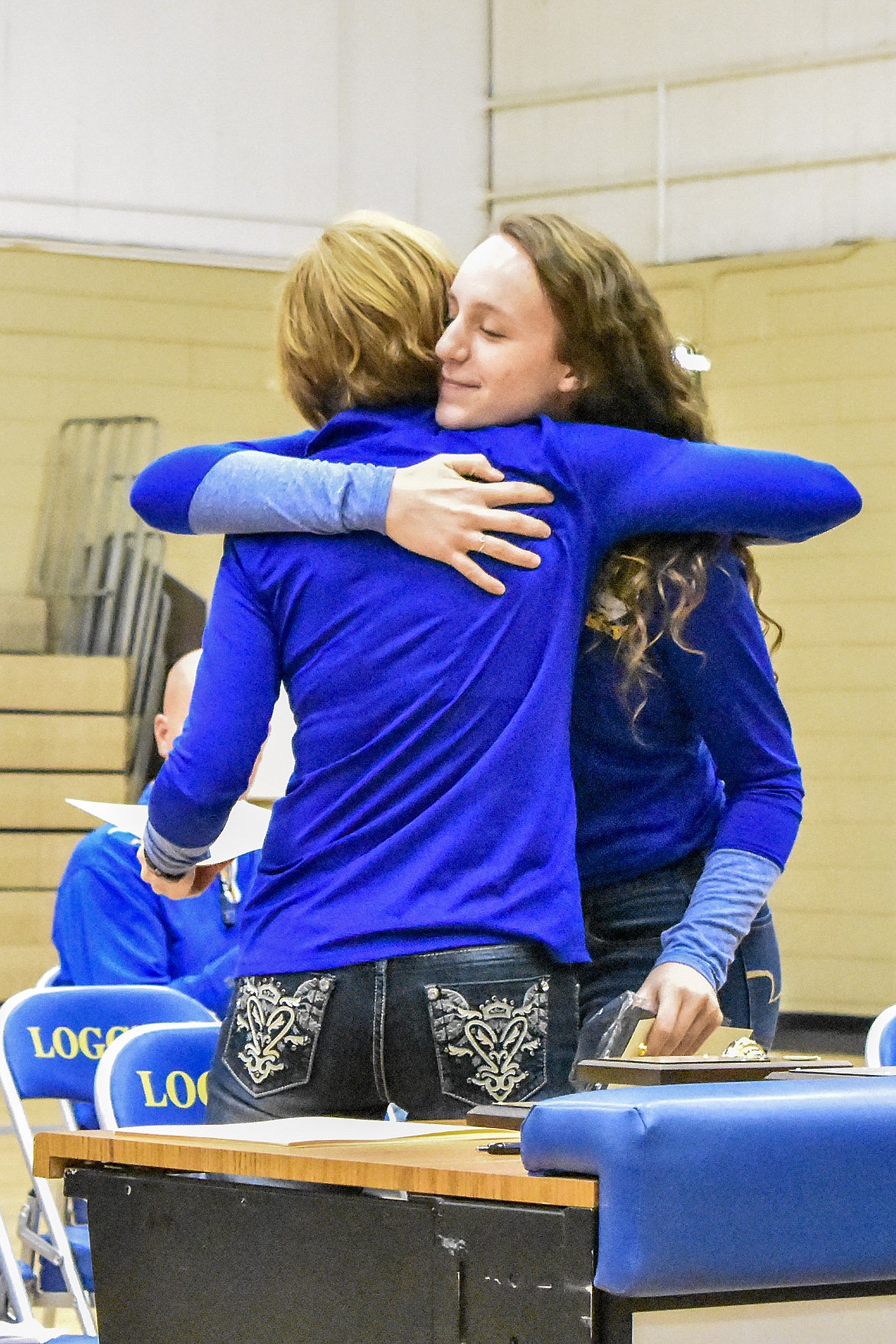 Libby High School volleyball Head Coach Cindy Ostrem-Johnston congratulates senior Jayden Winslow -- the player voted &#147;Most Valuable Player&#148;, she also made All State and First Team All Conference -- during the Fall Awards Assembly Thursday. (Ben Kibbey/The Western News)