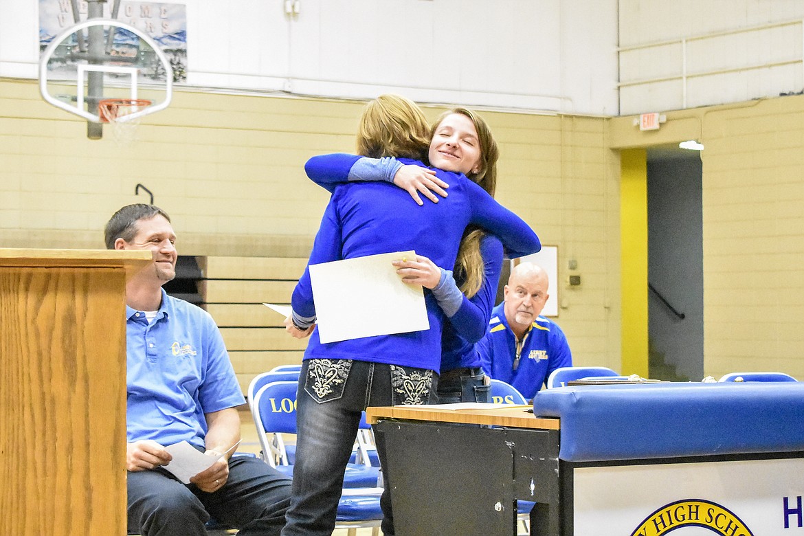 Libby High School volleyball Head Coach Cindy Ostrem-Johnston hugs senior Linsey Waker, Second Team All Conference, during the Fall Awards Assembly Thursday. (Ben Kibbey/The Western News)