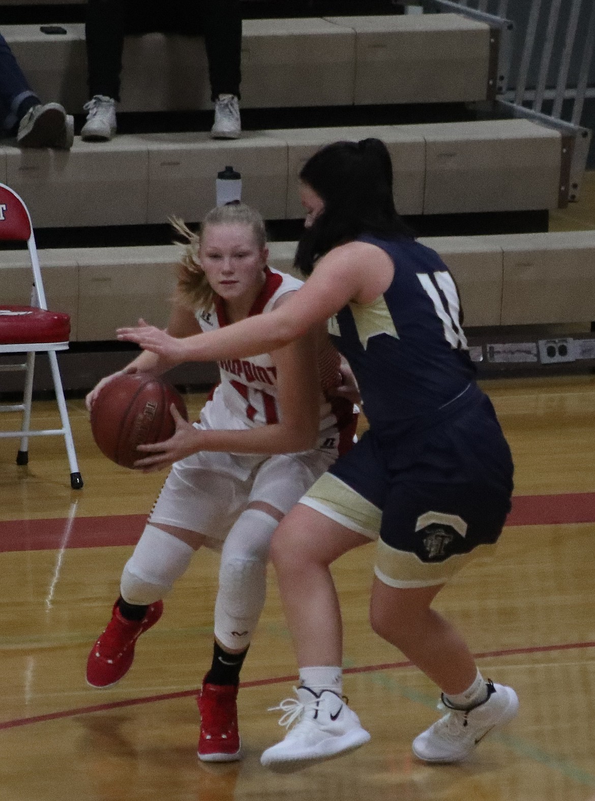 (Photo by KYLE CAJERO) Sandpoint junior Aly Lish looks for a teammate as Timberlake&#146;s Bernie Carhart applies pressure.